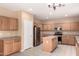 Spacious kitchen with stainless steel appliances, island, and ample light-colored wood cabinetry at 4255 E Cloudburst Ct, Gilbert, AZ 85297