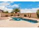 Private backyard pool surrounded by lush landscaping, rocks, and a pebble surface at 4255 E Cloudburst Ct, Gilbert, AZ 85297