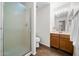 Bright bathroom showcasing a glass-enclosed shower and a wood vanity with a sink at 45 E 9Th Pl # 12, Mesa, AZ 85201