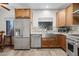 Bright kitchen featuring custom wood cabinets, stainless steel appliances, and a farmhouse sink at 45 E 9Th Pl # 12, Mesa, AZ 85201