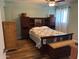 Cozy bedroom with a large headboard and ceiling fan, featuring a light blue and white quilt at 455 S Delaware Dr # 171, Apache Junction, AZ 85120