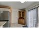 A breakfast nook with tile floor and sliding glass door next to a wooden china cabinet offers plenty of light at 455 S Delaware Dr # 171, Apache Junction, AZ 85120