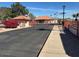 View of the entrance to the gated community with desert landscaping and American flags at 455 S Delaware Dr # 171, Apache Junction, AZ 85120