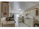 Well-lit kitchen featuring white appliances, ample counter space, and tile flooring for easy maintenance at 455 S Delaware Dr # 171, Apache Junction, AZ 85120