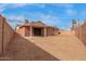 View of the backyard with a covered patio and brick perimeter walls at 4601 S 21St St, Phoenix, AZ 85040