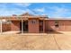 View of the backyard with a covered patio and brick perimeter walls at 4601 S 21St St, Phoenix, AZ 85040