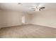 Neutral bedroom showing carpet, paint, open doorway, and ceiling fan at 4601 S 21St St, Phoenix, AZ 85040