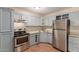 This cozy kitchen is equipped with stainless steel appliances and blue cabinets at 4601 S 21St St, Phoenix, AZ 85040