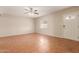 A cozy living room features tiled floors, a ceiling fan, and neutral walls at 4601 S 21St St, Phoenix, AZ 85040