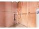 Utility room with water heater, plumbing, and exposed brick wall at 4601 S 21St St, Phoenix, AZ 85040