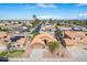 Overhead shot of a home in a suburban neighborhood, showcasing its tile roof and well-manicured yard at 474 W Smoke Tree Rd, Gilbert, AZ 85233