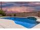 Relaxing backyard pool with a water feature and decorative string lights providing a serene outdoor ambiance for evening enjoyment at 474 W Smoke Tree Rd, Gilbert, AZ 85233