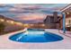 Night view of the serene backyard pool and outdoor lights create a relaxing ambiance for unwinding after a long day at 474 W Smoke Tree Rd, Gilbert, AZ 85233