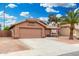 Ranch-style home featuring desert landscaping, a two-car garage, and an American flag at 474 W Smoke Tree Rd, Gilbert, AZ 85233