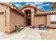 Charming front entrance with a covered porch, seating, and well-manicured landscaping at 474 W Smoke Tree Rd, Gilbert, AZ 85233