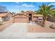 Charming single-story home featuring a two-car garage, desert landscaping, and a welcoming entryway at 474 W Smoke Tree Rd, Gilbert, AZ 85233