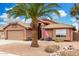 Inviting home exterior featuring desert landscaping, American flag, mature palm tree, and neutral color scheme at 474 W Smoke Tree Rd, Gilbert, AZ 85233