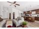 Inviting living room with comfortable seating, a ceiling fan, and an open flow to the kitchen at 474 W Smoke Tree Rd, Gilbert, AZ 85233