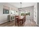 Bright dining room with wood floors, a large table for eight, and a modern chandelier at 5513 S Coyote Cyn, Mesa, AZ 85212