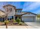 Charming two-story home featuring a gray painted exterior, well-kept landscaping, and an attached two-car garage at 5513 S Coyote Cyn, Mesa, AZ 85212