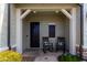 Charming front porch with rocking chairs, decorative pillows, rug and stone accents at 5513 S Coyote Cyn, Mesa, AZ 85212