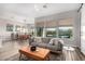 Open-concept living room with large windows, a view of the pool, and access to the dining area at 5513 S Coyote Cyn, Mesa, AZ 85212