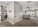 Spacious living room with carpet flooring leading to a hallway and additional living area at 5513 S Coyote Cyn, Mesa, AZ 85212