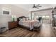 Spacious main bedroom featuring a ceiling fan, wood floors, and ample natural light from large windows at 5513 S Coyote Cyn, Mesa, AZ 85212