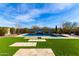 Inviting pool and well-manicured backyard with green turf and stone pavers for outdoor living at 5513 S Coyote Cyn, Mesa, AZ 85212