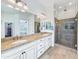 Bathroom with dual sinks, granite counters, a walk-in shower, and a view to the main bedroom at 6039 E Sienna Bouquet Pl, Cave Creek, AZ 85331