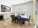 Inviting dining room with a bar area, wood table and six chairs, tile floors, and modern decor at 6039 E Sienna Bouquet Pl, Cave Creek, AZ 85331