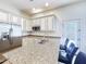 Kitchen with stainless steel appliances, granite countertops, white cabinets, and bar seating at 6039 E Sienna Bouquet Pl, Cave Creek, AZ 85331