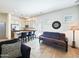 Open-concept living room featuring a sofa, futon, breakfast bar, and seamless transition to the kitchen at 6039 E Sienna Bouquet Pl, Cave Creek, AZ 85331