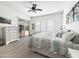 Bright main bedroom features a ceiling fan, white plantation shutters, and sliding doors to the backyard at 6039 E Sienna Bouquet Pl, Cave Creek, AZ 85331