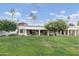 Large grassy backyard with covered patios, offering an inviting outdoor living space at 617 S Palo Verde Way, Mesa, AZ 85208