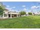 This beautiful backyard features a well-maintained lawn, covered patio, and ample space for outdoor entertaining at 617 S Palo Verde Way, Mesa, AZ 85208