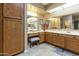 Well-lit bathroom with dual sinks, a vanity area, and ample storage space in wooden cabinets at 617 S Palo Verde Way, Mesa, AZ 85208