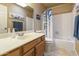 Bathroom featuring a vanity with a white countertop, a mirror, and a shower-tub combination at 617 S Palo Verde Way, Mesa, AZ 85208