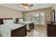 Bright bedroom featuring two twin beds, a ceiling fan, and a sunlit bay window at 617 S Palo Verde Way, Mesa, AZ 85208