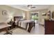 Comfortable main bedroom with access to the outdoors and featuring neutral tones, a ceiling fan, and an ensuite bathroom at 617 S Palo Verde Way, Mesa, AZ 85208