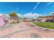 Spacious backyard features a playset, pergola, stone pavers, grass, and various outdoor features at 6208 N 78Th Dr, Glendale, AZ 85303