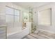 Bright bathroom featuring a soaking tub and glass enclosed shower at 6208 N 78Th Dr, Glendale, AZ 85303