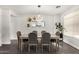 Bright dining room with unique chandelier, stylish mirror, and seating for six at 6208 N 78Th Dr, Glendale, AZ 85303