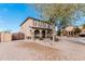 Charming two-story home with desert landscaping, featuring a gated entrance and inviting front porch with stone pillars at 6208 N 78Th Dr, Glendale, AZ 85303