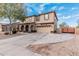 Charming two-story home featuring a two-car garage and inviting front porch with stone pillars and desert landscaping at 6208 N 78Th Dr, Glendale, AZ 85303