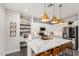 Stylish kitchen with island seating, stainless steel appliances, and modern pendant lights at 6208 N 78Th Dr, Glendale, AZ 85303