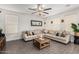 Comfortable living room with a large sectional, ceiling fan, and neutral color scheme at 6208 N 78Th Dr, Glendale, AZ 85303