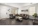 Elegant living room with gray sofas, mirrored coffee table, wood-look floors, and natural light from the window at 6208 N 78Th Dr, Glendale, AZ 85303