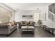 Bright and airy living room featuring gray sofas, a mirrored coffee table, wood-look floors and natural light from windows at 6208 N 78Th Dr, Glendale, AZ 85303