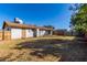 Exterior view of the back of the home and backyard with lawn at 658 S Sycamore St # Value, Mesa, AZ 85202